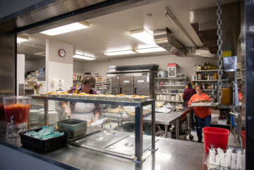 Chefs at Snohomish Senior Center work in a modern kitchen with energy-efficiency updates