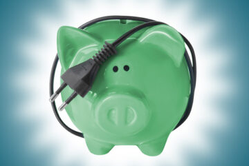 Income qualified piggy bank with electrical cord tail on blue background