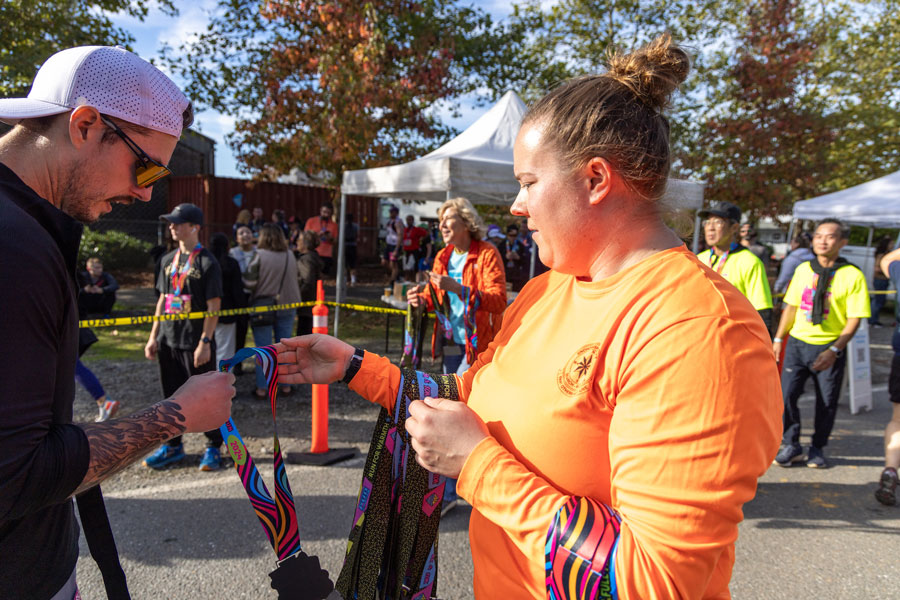 Search and Rescue Workers wear bright orange and hand out medals after the reace